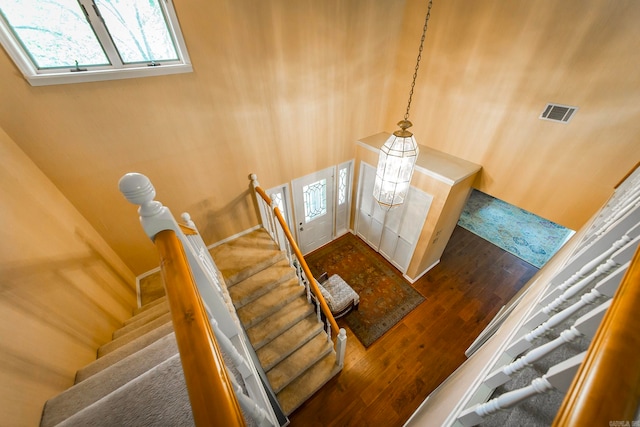 staircase with hardwood / wood-style floors