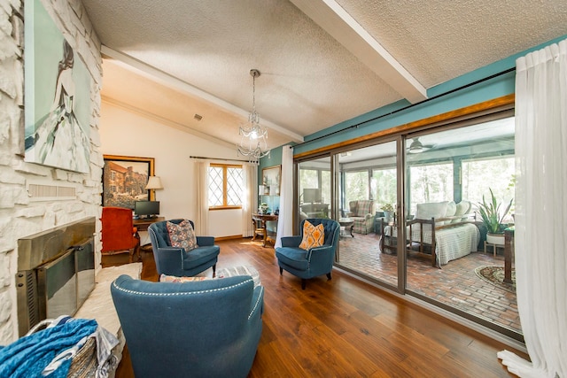 interior space featuring a textured ceiling, vaulted ceiling with beams, a fireplace, and hardwood / wood-style flooring