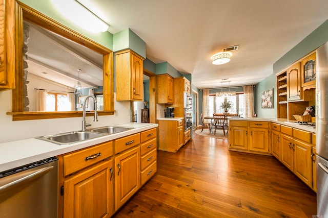 kitchen featuring an inviting chandelier, stainless steel appliances, dark wood-type flooring, and decorative light fixtures