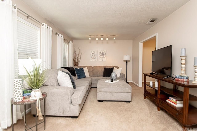 carpeted living room with a textured ceiling