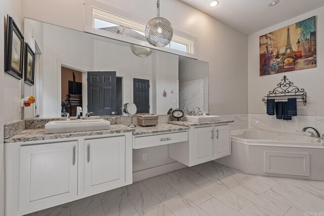 bathroom featuring vanity and a tub to relax in