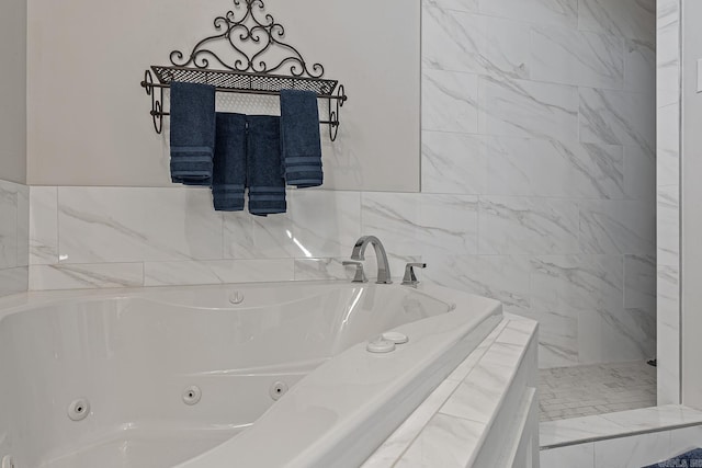 bathroom featuring tiled tub