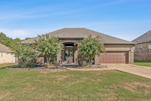 view of front of house with a front yard and a garage