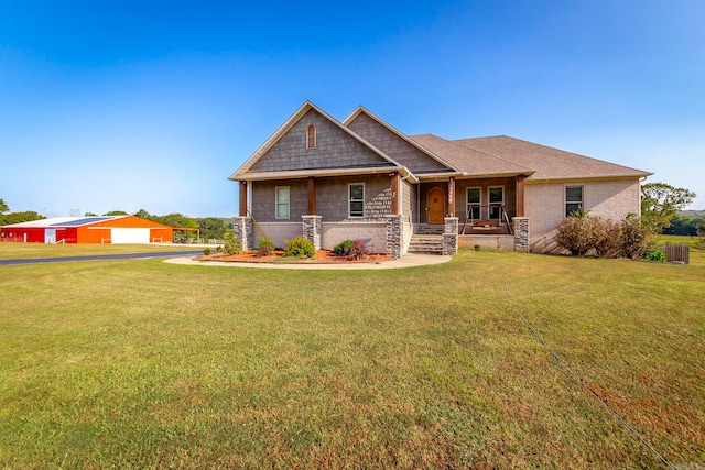 craftsman inspired home featuring a front lawn and covered porch