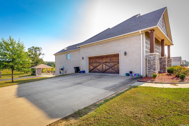 view of home's exterior with a yard and a garage