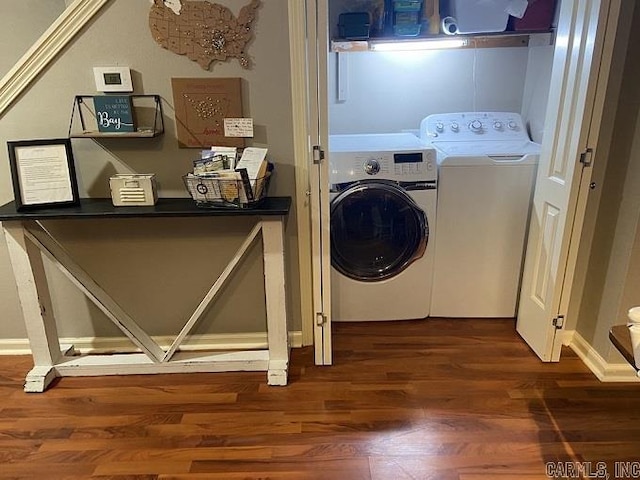 laundry room featuring washing machine and dryer and dark hardwood / wood-style floors