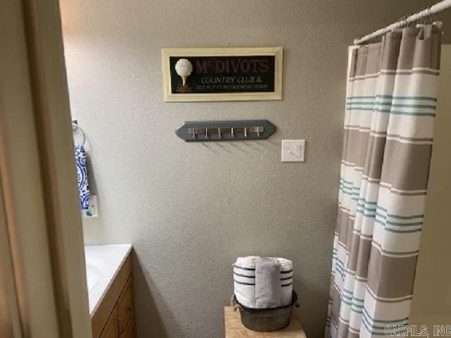 bathroom with vanity and curtained shower