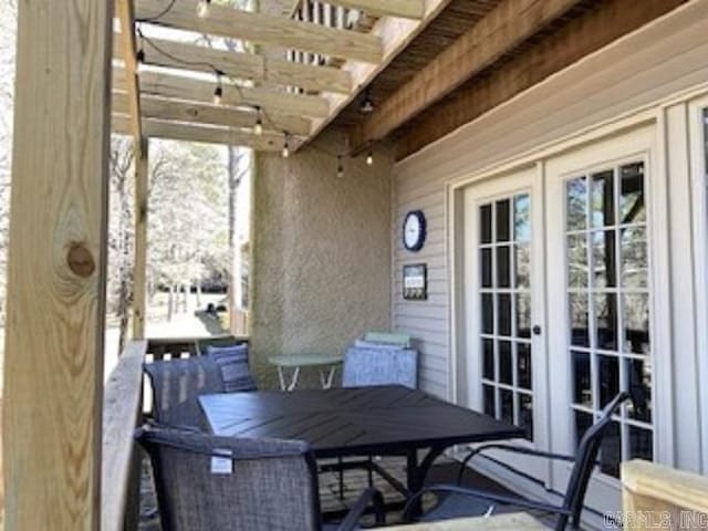 exterior space featuring french doors, plenty of natural light, and beam ceiling