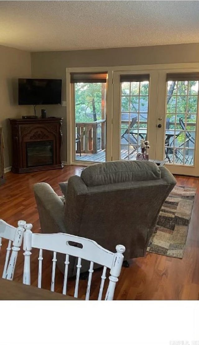 living room featuring hardwood / wood-style flooring and a textured ceiling