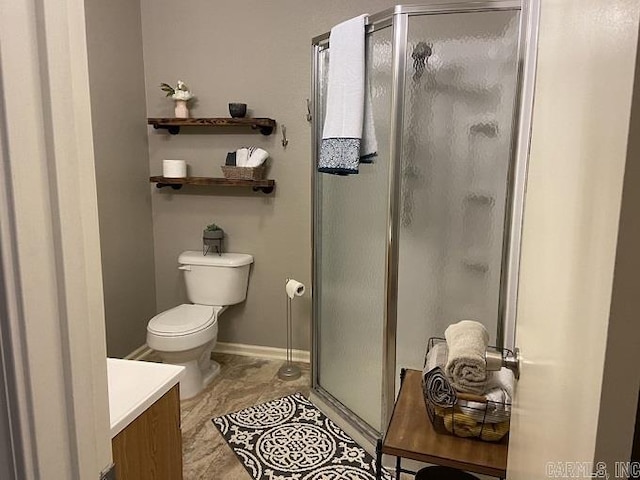 bathroom with walk in shower, vanity, and toilet