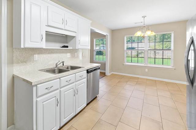 kitchen featuring appliances with stainless steel finishes, a chandelier, and white cabinets