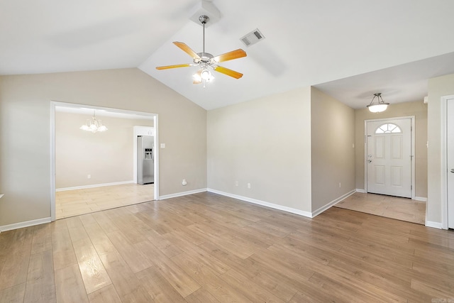 interior space featuring wood-type flooring, ceiling fan with notable chandelier, and lofted ceiling