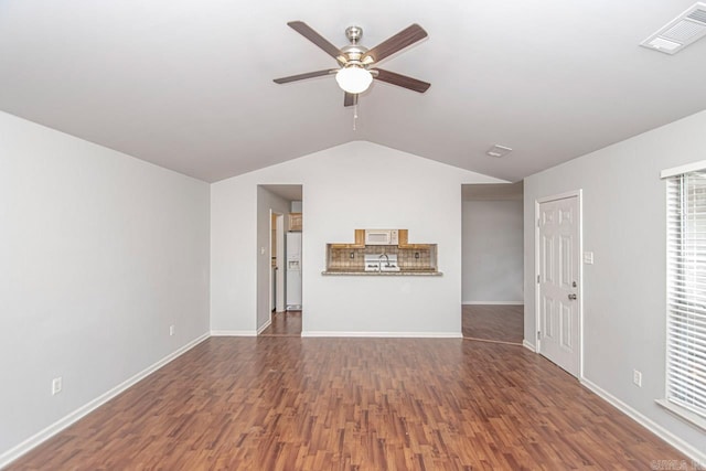 unfurnished living room with ceiling fan, dark hardwood / wood-style floors, and vaulted ceiling