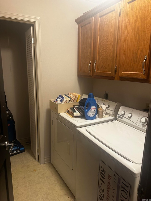 laundry room with cabinets and washing machine and clothes dryer