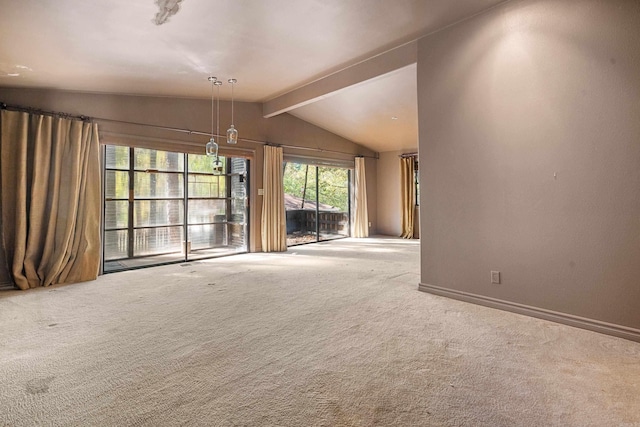 unfurnished living room with vaulted ceiling with beams and carpet