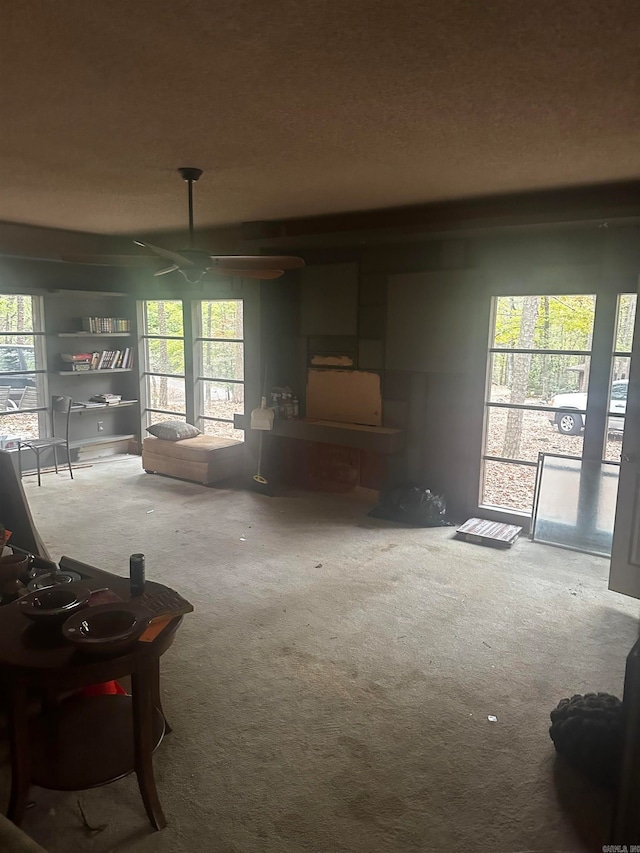 carpeted living room featuring ceiling fan