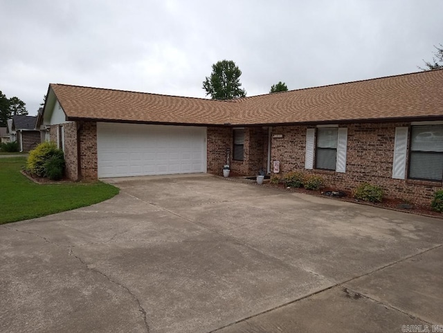 2804 Jerry Lee, Mena, AR 71953 - ranch-style house featuring concrete driveway, brick siding, a shingled roof, and a garage