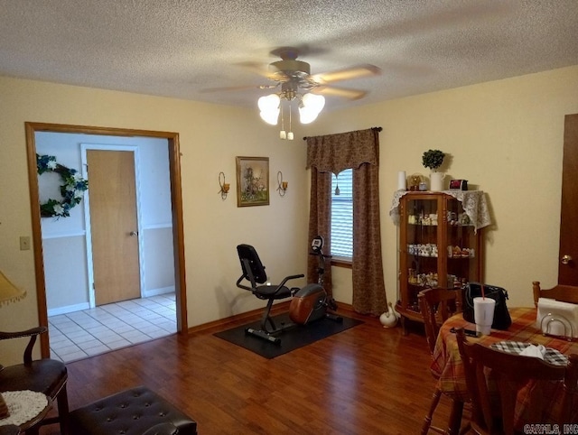 interior space featuring ceiling fan, a textured ceiling, and light hardwood / wood-style floors