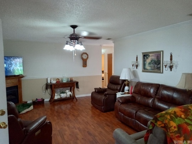 living room with ceiling fan, crown molding, hardwood / wood-style floors, and a textured ceiling