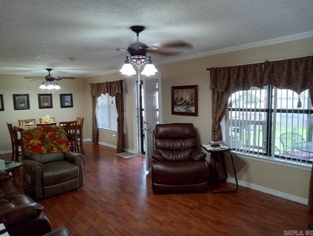 living room with ceiling fan, ornamental molding, a textured ceiling, and dark hardwood / wood-style flooring