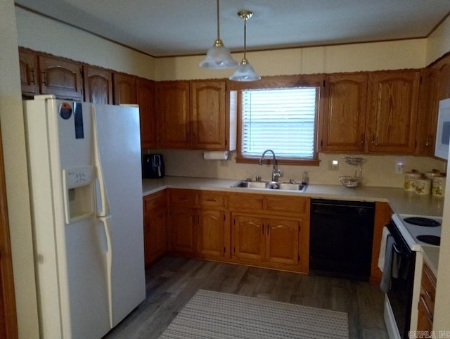 kitchen featuring hardwood / wood-style floors, white appliances, sink, and decorative light fixtures