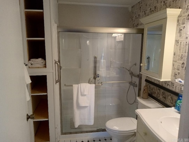 bathroom featuring crown molding, vanity, toilet, and an enclosed shower