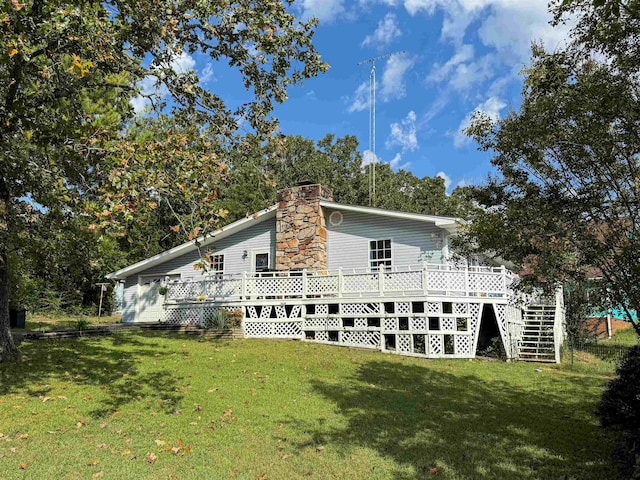 view of property exterior featuring a yard, a wooden deck, stairs, and a chimney