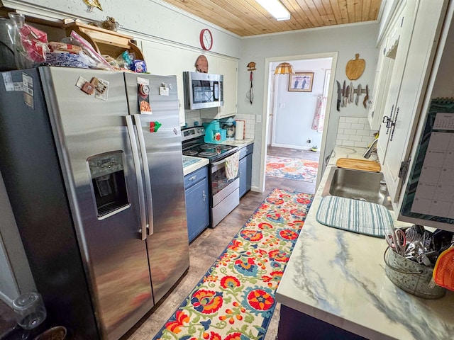 kitchen with blue cabinets, white cabinetry, appliances with stainless steel finishes, and wooden ceiling