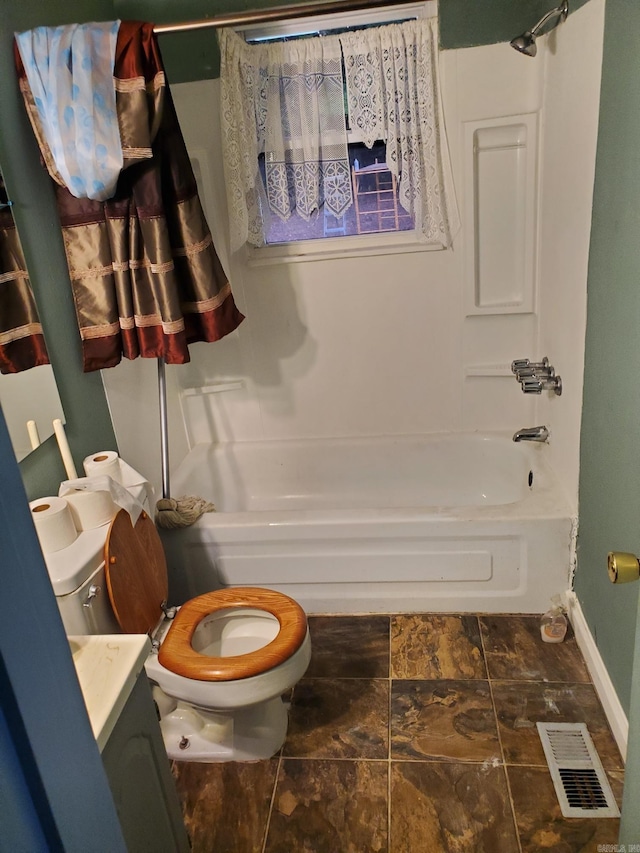 full bathroom with shower / tub combo with curtain, vanity, and toilet