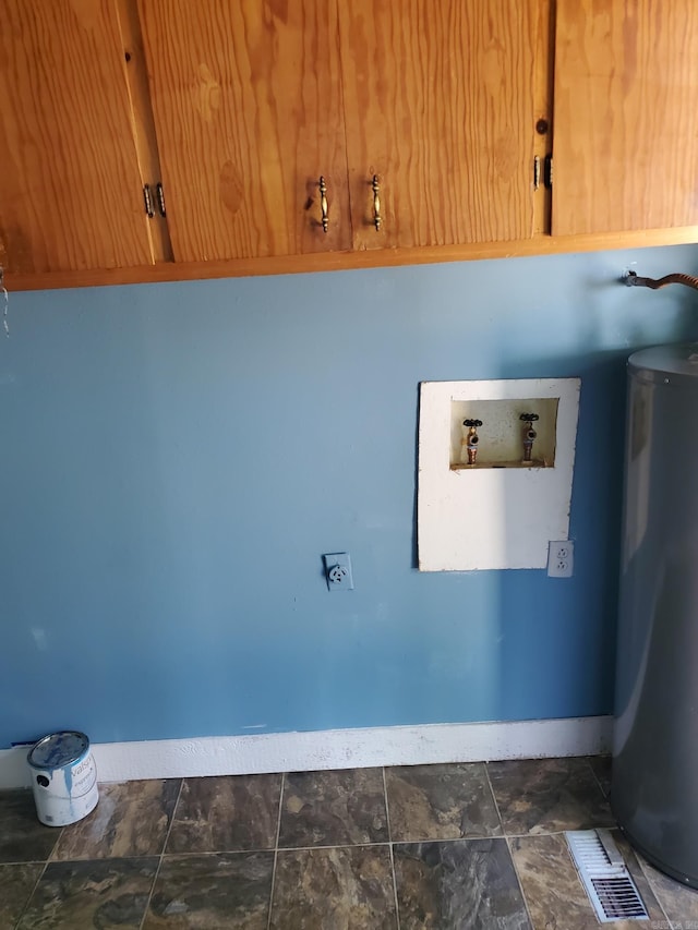 laundry room with hookup for a washing machine, water heater, and cabinets