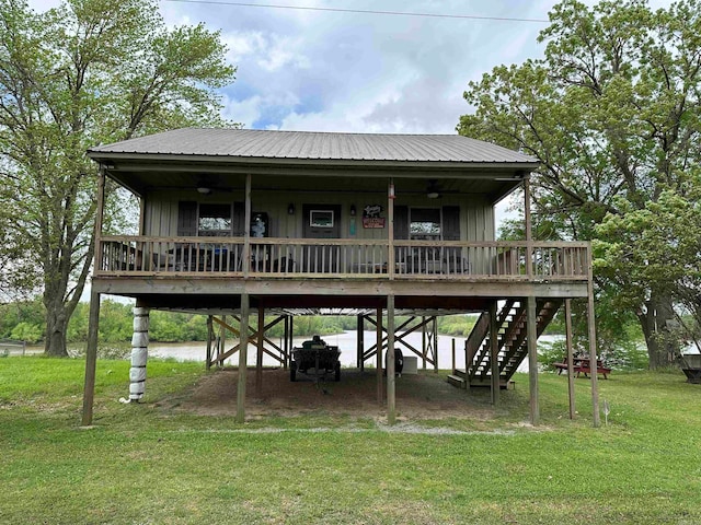 back of house with a lawn, ceiling fan, and a deck