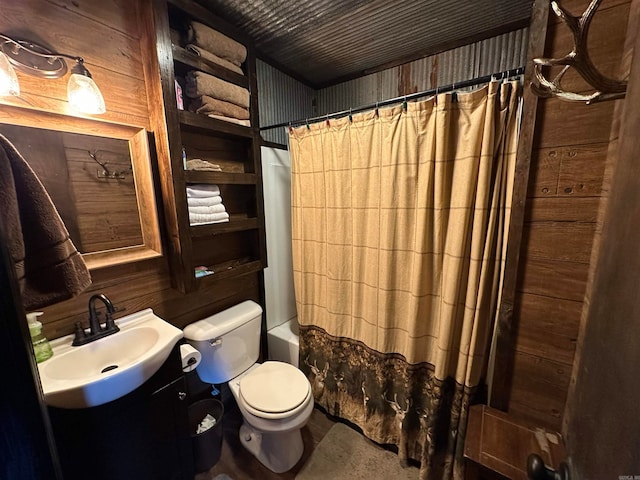 full bathroom featuring shower / bath combo, wood walls, toilet, and vanity