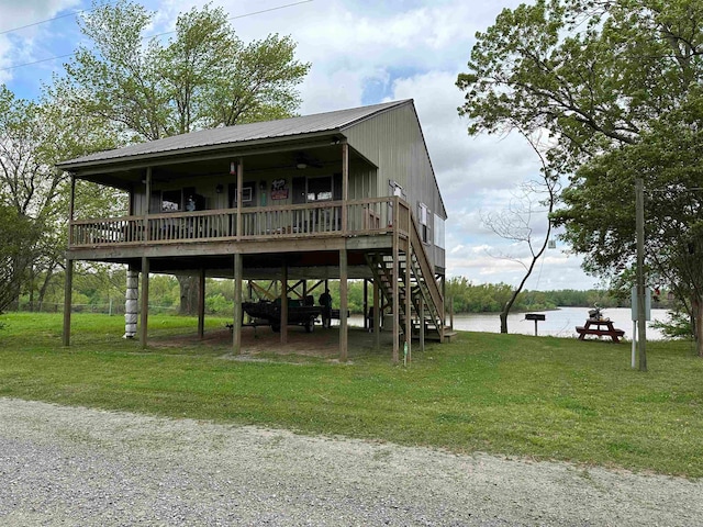 exterior space with a front lawn and a deck with water view