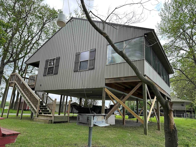 back of property with a lawn and a deck