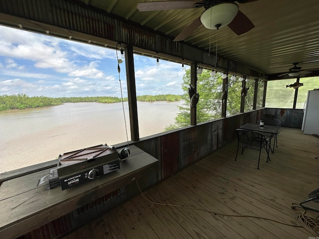 exterior space with a water view and ceiling fan