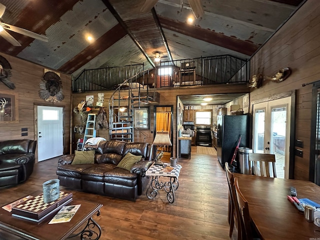 living room with ceiling fan, beam ceiling, high vaulted ceiling, and a healthy amount of sunlight