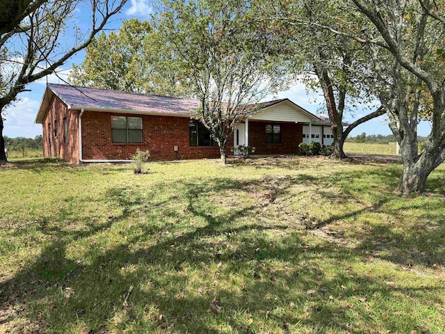 ranch-style home featuring a front yard