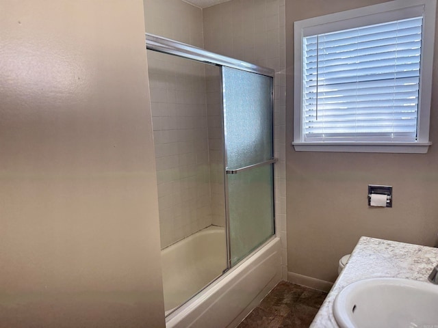 bathroom featuring vanity and combined bath / shower with glass door