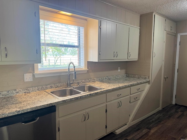 kitchen with dishwasher, sink, a textured ceiling, and white cabinets