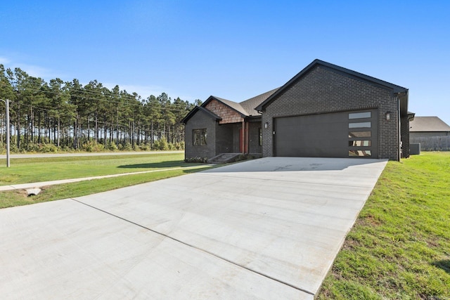 view of front of house featuring a front yard, a garage, and a water view