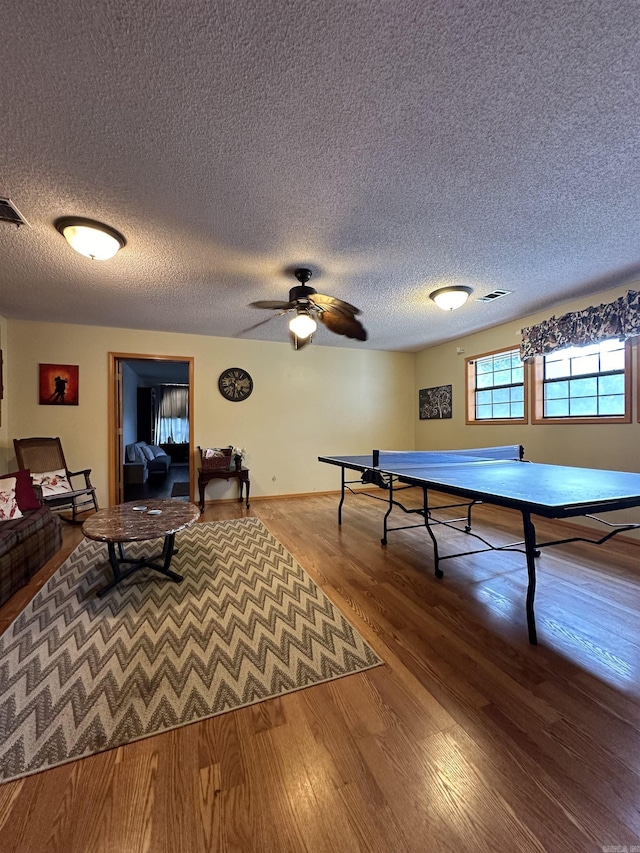 3409 Ramsgate, Fort Smith, AR 72908 - playroom featuring visible vents, a textured ceiling, wood finished floors, and a ceiling fan