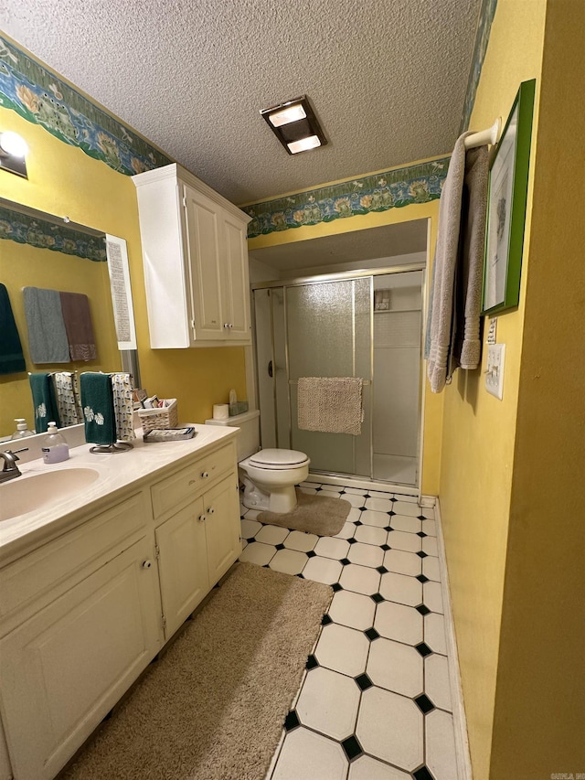 3409 Ramsgate, Fort Smith, AR 72908 - bathroom featuring vanity, toilet, a textured ceiling, tile patterned floors, and a stall shower