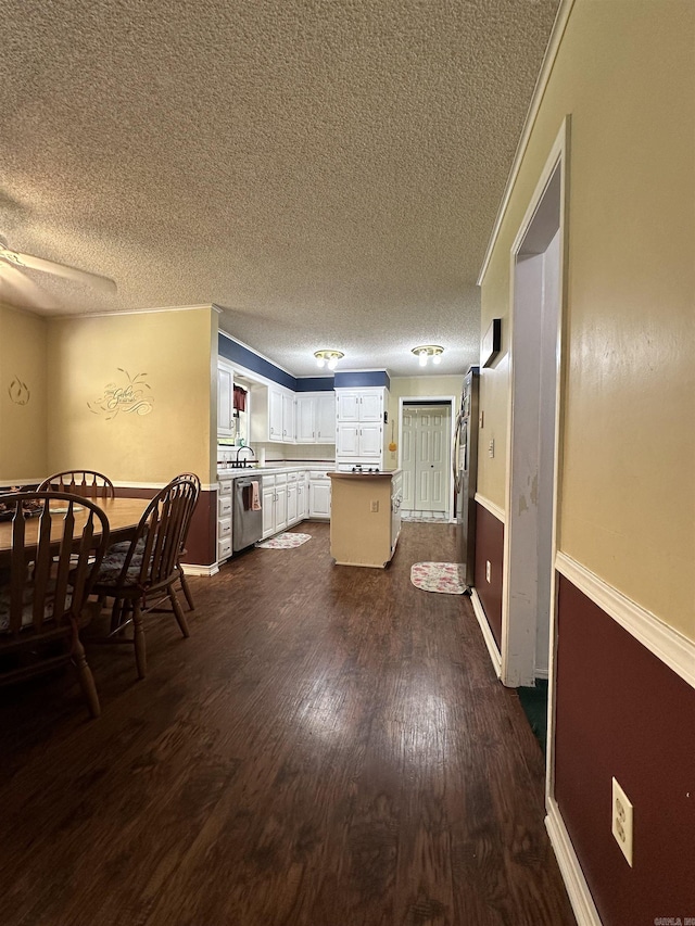 3409 Ramsgate, Fort Smith, AR 72908 - kitchen with white cabinets, a ceiling fan, appliances with stainless steel finishes, a sink, and dark wood-style floors