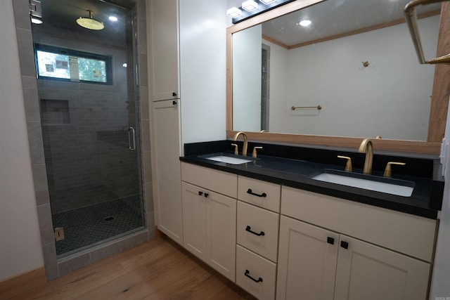 bathroom featuring vanity, an enclosed shower, ornamental molding, and hardwood / wood-style flooring