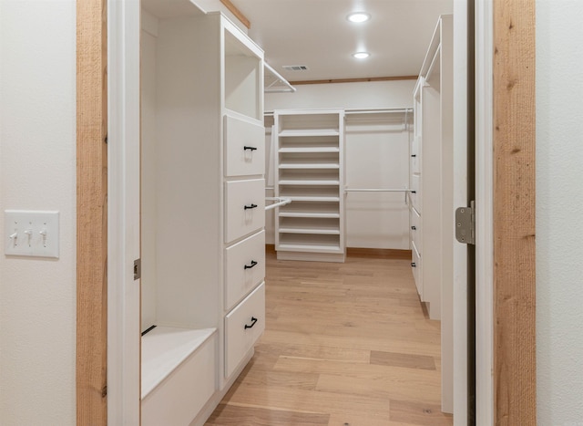 walk in closet featuring light hardwood / wood-style flooring