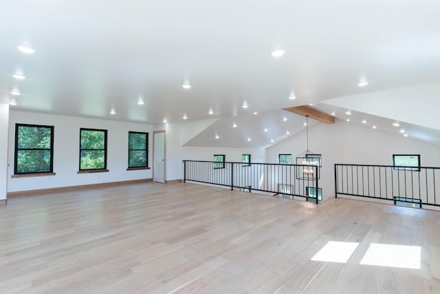 bonus room with a chandelier, vaulted ceiling with beams, and light hardwood / wood-style floors