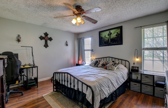 bedroom featuring ceiling fan, a textured ceiling, and dark hardwood / wood-style flooring