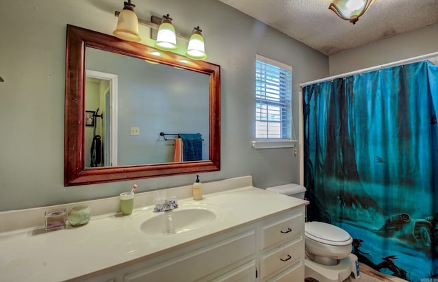 bathroom featuring vanity, toilet, a textured ceiling, and curtained shower