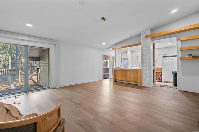 interior space featuring light hardwood / wood-style floors and vaulted ceiling