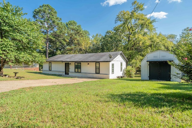 ranch-style home featuring a storage shed, a porch, and a front yard